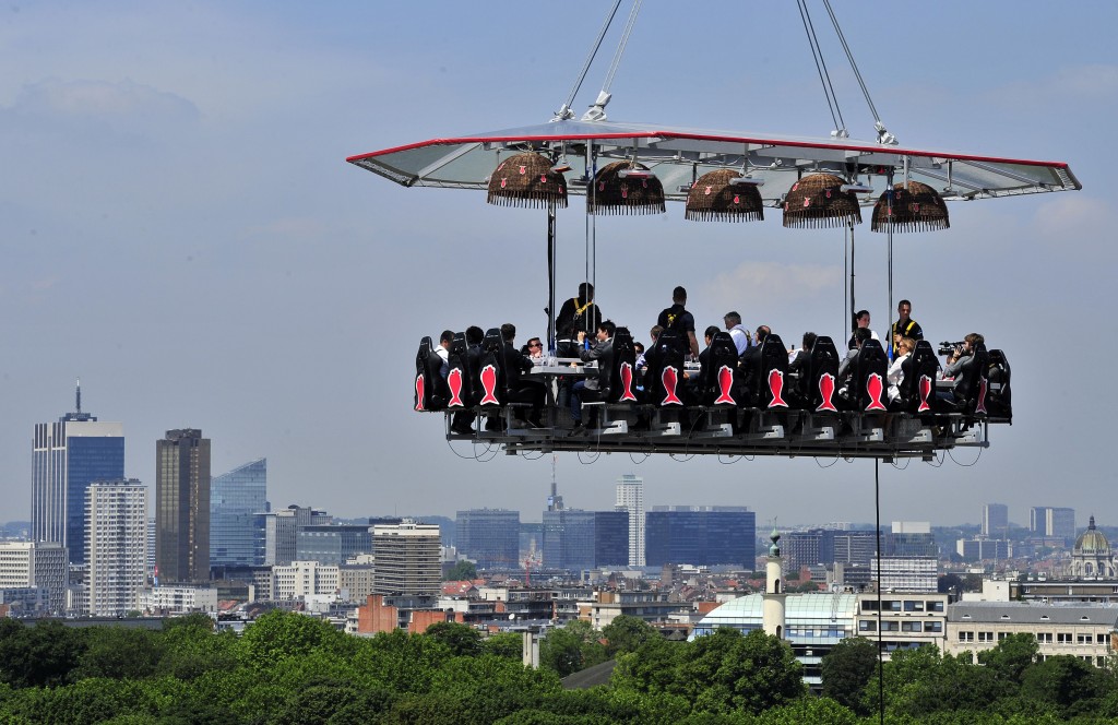 TOPSHOTS Diners take lunch suspended in the air on June 2, 2014 above the Parc du Cinquantenaire in Brussels."Dinner in the sky" is an "unique occasion" to discover Brussels's high cuisine and enjoy a spectacular view of the city from the air. 22 guests, strapped into their chairs with harnesses, sit around the mini kitchen where a 'starred' chef prepares and serves the meals and the wine. Brussels wants to become an essential actor of the European gastronomic scene. With its 19 starred restaurants, the EU capital has now more stars than Berlin, Rome, or Milan. "Brussels in the Sky" takes place until June 29th at the Parc du Centenaire, close to the European area. Italy is the guest of honour at this 3rd edition. AFP PHOTO/ GEORGES GOBETGEORGES GOBET/AFP/Getty Images ORG XMIT: BELGIUM-G