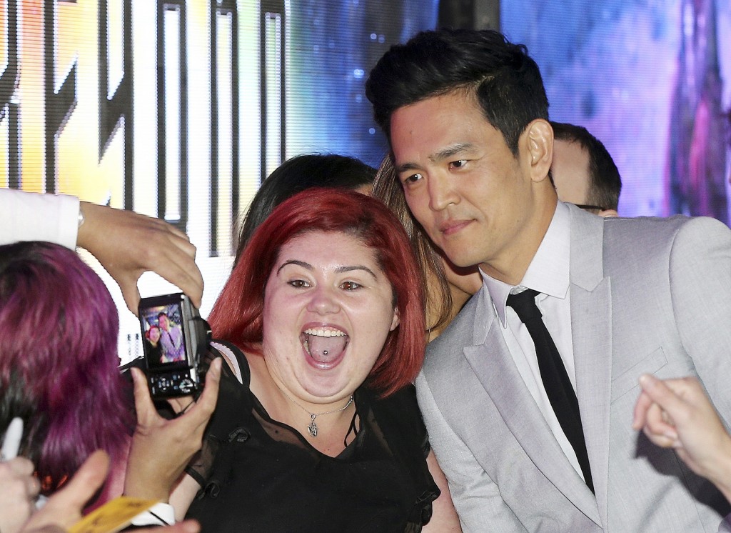 Actor John Cho poses for a photo with a fan as he walks the red carpet during the premier of "Star Trek Beyond" in Sydney, Australia, Thursday, July 7, 2016. (AP Photo/Rob Griffith)